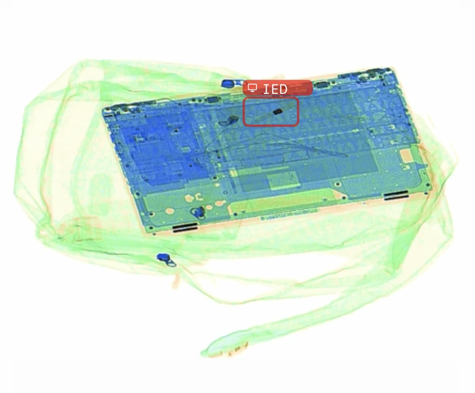 AI X-ray detection flagging an IED component concealed inside a laptop