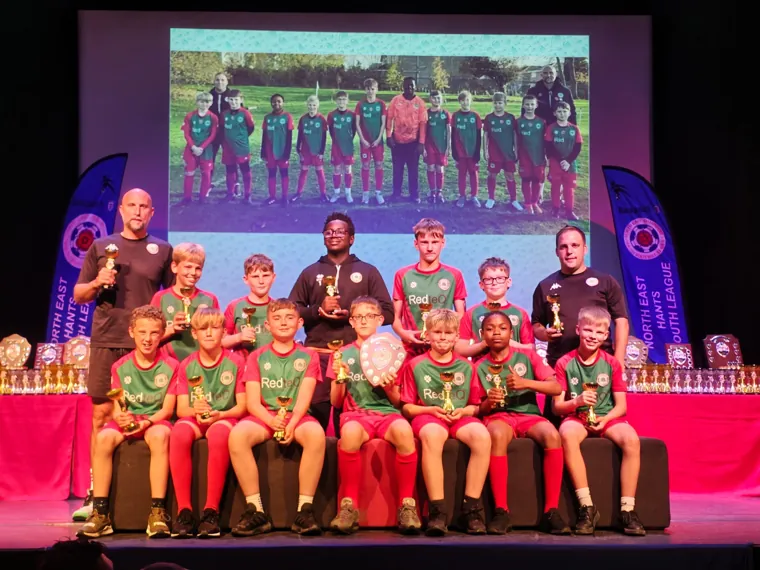 Ash United U12 Stars on stage at the North East Hants Youth League presentation evening after winning Division 7 in the 2025/26 season