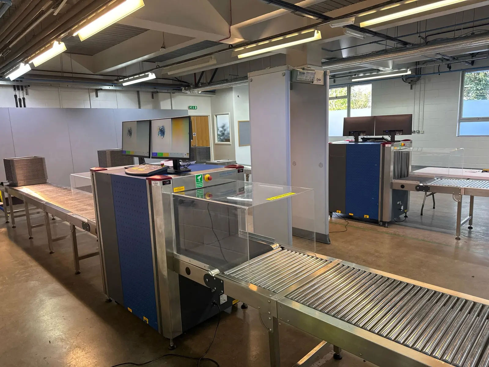 Complete security checkpoint with X-ray machines and a walk-through metal detector supplied by RedteQ