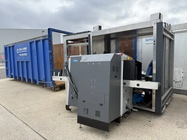 Decommissioned X-ray machine beside recycling containers during a RedteQ strip-down